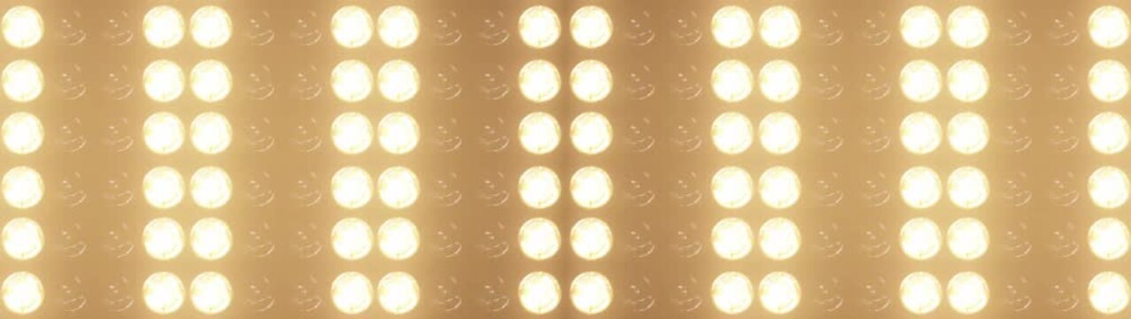 Widescreen flashing lights with bright warm lamps pulsing in patterns, perfect for music videos, club events, and show intros, concert visuals and dynamic stage backgrounds	
