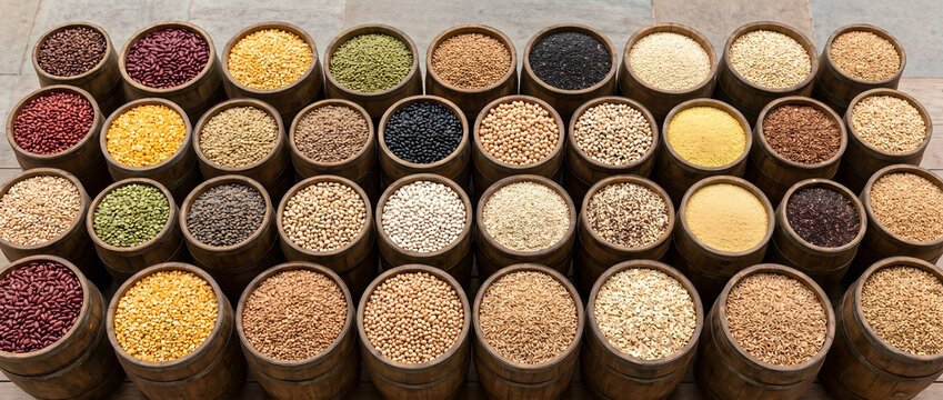 Wooden containers filled with various types of grains and legumes in close-up view