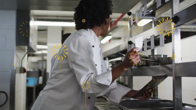 Chef reading tablet lifting ticket, placing on kitchen pass rail, gold sparks growing marking ready
