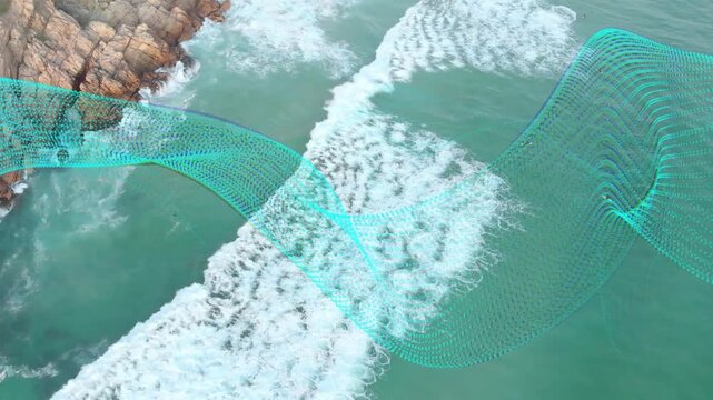 Drone panning, aqua mesh ribbon waving across breaking surf by rocky shore, mapping for marine tech