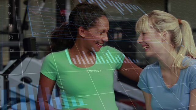 Woman in blue touching pregnant belly, starting HUD overlaying grids and charts in fitness, smiling