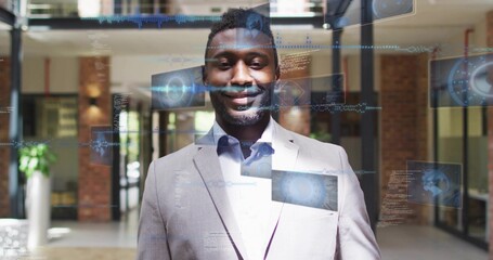 Obraz premium Standing executive wearing light gray suit and white shirt in office lobby, with holograms