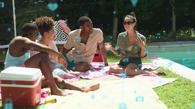 Group talking and gesturing on pink blanket by pool, chat starting blue icons drifting for creators