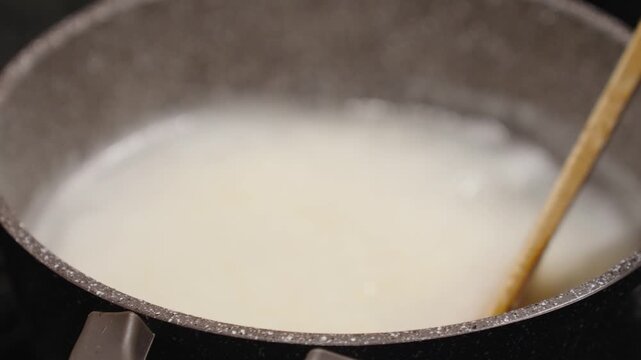 Cooking ghomi, a popular dish from the Samegrelo region made with coarse white corn flour