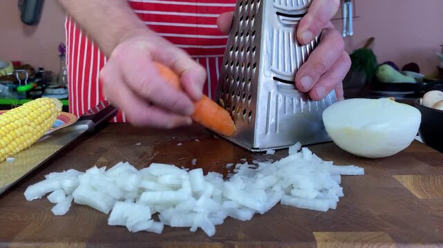 Chef is grating carrots to prepare a fresh and nutritious homemade dish, with chopped onion and corn at the ready.