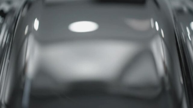 Close up view of reflective, shiny, glass surface with ambient light, abstract background, modern clean design
