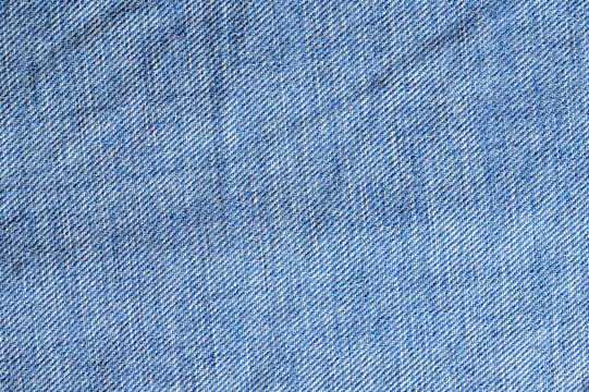Close-up texture of classic blue denim fabric with diagonal weave pattern