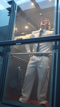 Vertical screen defeated professional stands in silence hands on hips processing failure and lost opportunity reflecting on setback and consequences after unsuccessful outcome