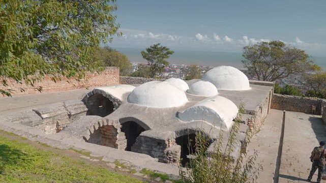Coastal Bathhouse Scene. Quiet Coastal Area Showcasing Traditional Bathing Architecture At Midday. Creative