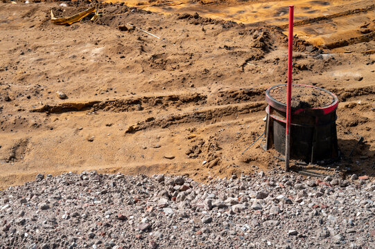 Manhole with red stake on a construction site