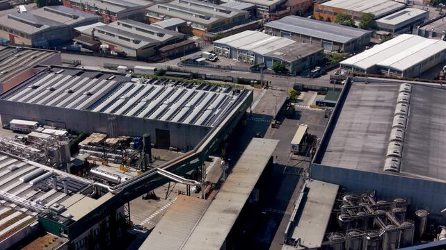 Industrial Landscape: An aerial view showcases an expansive industrial complex, revealing a network of factories, warehouses, and storage facilities.