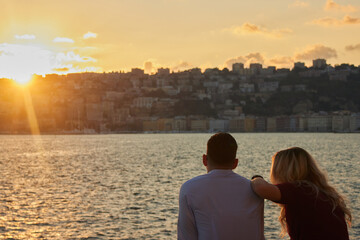Fototapeta premium People looking at the Bay of Naples at sunset in Naples, Italy
