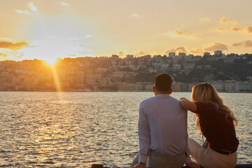 Fototapeta premium People looking at the Bay of Naples at sunset in Naples, Italy