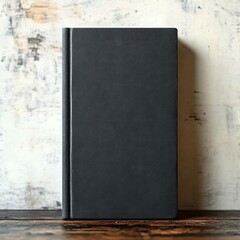 Fototapeta premium black hardcover journal standing upright on wooden table against distressed white wall, minimalist still life conveying calm and contemplative mood