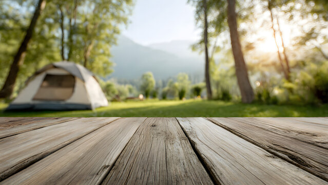 Rustic wooden table with blurred background of peaceful camping tent in lush forest, majestic mountains, and warm sunset, ideal for nature product display