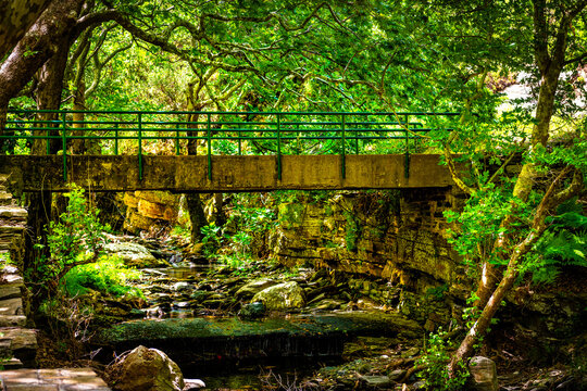 Old watermill bridge of Aris river at fishing village of Karavostamo on Ikaria island, Greece at longevity blue zone