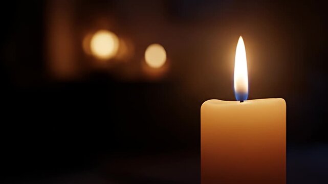 Candle's serene glow illuminates the darkness with bokeh highlights in the background