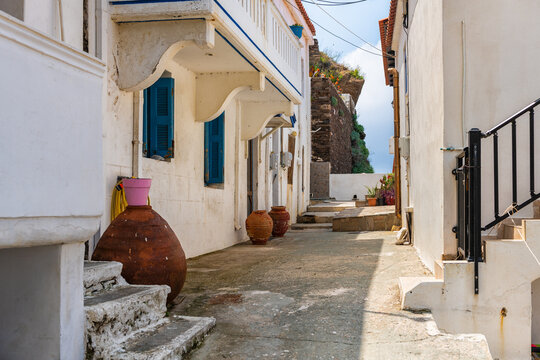 Karavostamo, Ikaria Greece small Greek fishing village street cityscape with residential home house building by street road
