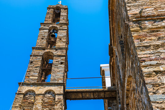 Arethousa village with Saint St Marina Greek Christian Orthodox church bell tower bridge slate architecture on Ikaria, Greece with broken cross