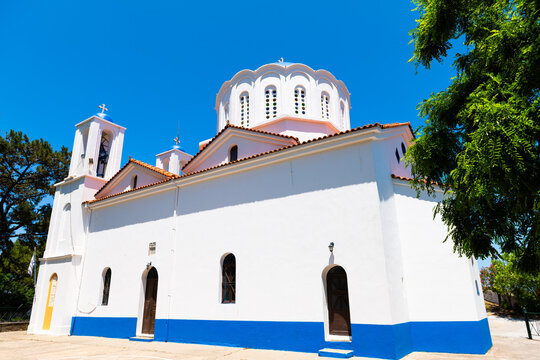Perdiki village on Ikaria island, Greece by Saint Matrona Greek Orthodox church by street road of longevity blue zone small mountain town
