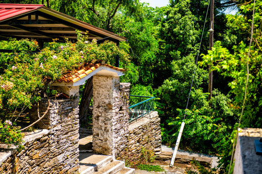 Perdiki village on Ikaria island, Greece home house building gate of stone rock slab slate masonry stonework by street road at longevity blue zone