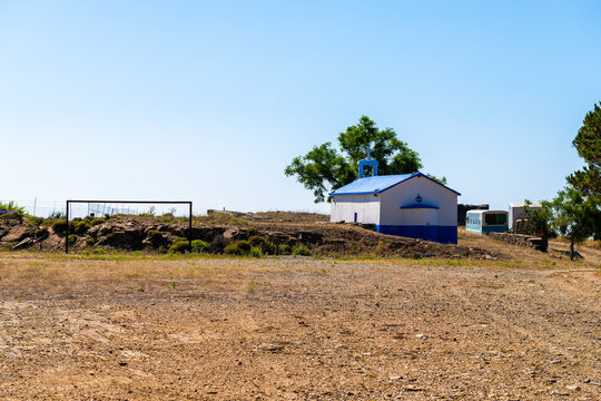 Soccer football dirt dry field gate at Perdiki mountain village on Ikaria island, Greece rural countryside small town at longevity blue zone