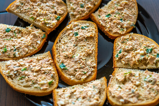 Tuna salad sandwich, many sandwiches on black plate in kitchen, homemade food macro closeup table top flat view