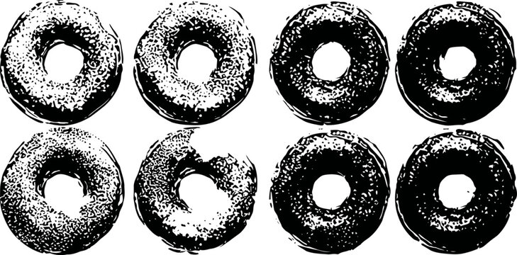 Eight black and white donuts arranged in two rows with one bitten donut in the bottom row