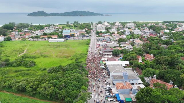 Aerial view of the street block carnival named Samambloco on the street of the town of Campeche, Florianopolis, Brazil