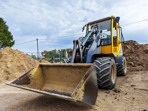 skid steer loader machine for earthmoving on construction site. earthmoving machine for leveling ground.