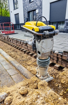 Vibratory rammer at a construction site for soil compaction