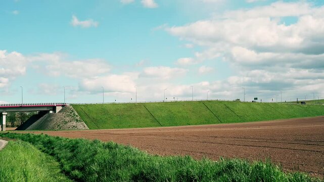 Passing cars next to fields 