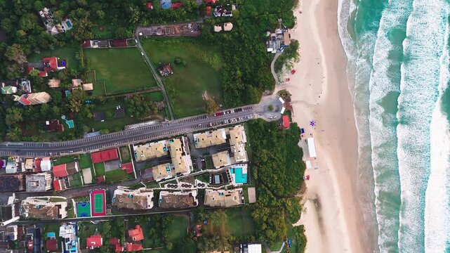 Aerial top down view of the Santinho beach during sunrise on the island of Santa Catarina. Florianopolis, Brazil
