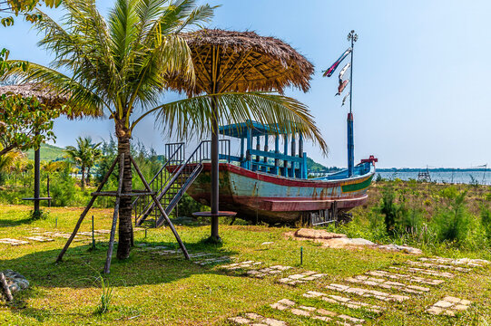 A view towards a beached sampan beside an oyster farm on the Lap An Lagoon in Vietnam on a bright sunny day