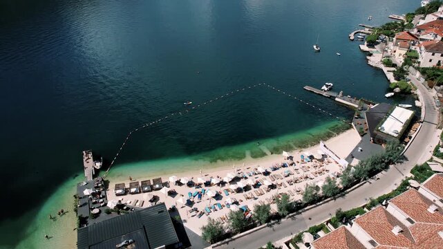 Exclusive seaside hotel with scenic views. Opulent beachside resort showcasing tranquil waters and mountains