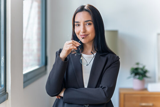 Elegant businesswoman posing and looking at camera in the office