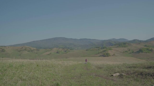 Skydiver after landing in wilderness area. Extreme sports, adrenaline, risk, challenges.