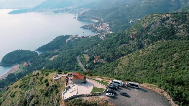 Chapel scene overview. Vantage of church overlooking water. Scenic view of chapel and surrounding landscape