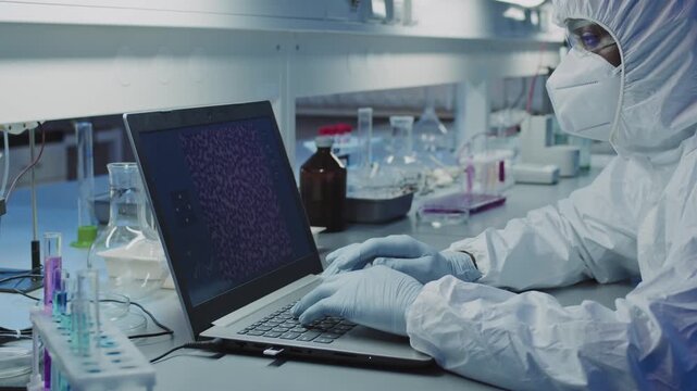 Docktor laptop working in the lab room. Caucasian professional entering data focused at work in the working place