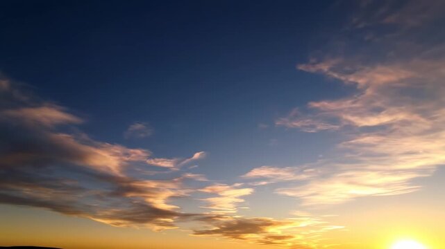 Beautiful sunset sky with golden clouds and deep blue atmosphere at dusk