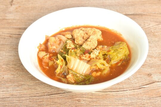 boiled mixed vegetable and fish egg in Thai spicy curry soup on bowl