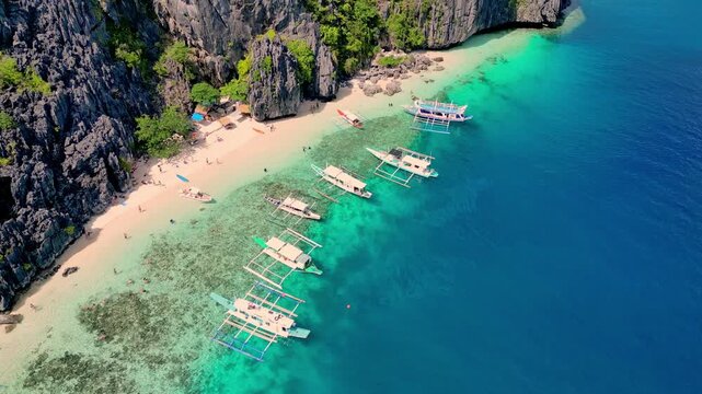 Lively Coast With Maritime Activity. Coastal Scene Filled With Ships And Towering Limestone Formations