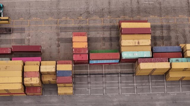 Santo Stefano di Magra, Italy - 18 April 2026: Aerial view of colorful shipping containers stacked at the Retroporto merci logistics hub in Liguria.