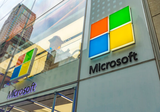 New York, United States - April 5, 2026: The colorful, illuminated logo of the Microsoft Experience Center is mounted on the sleek glass facade of its flagship location on Fifth Avenue