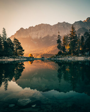 Eibsee lake with crystal clear water and mountain reflection at sunrise in Bavaria, Germany