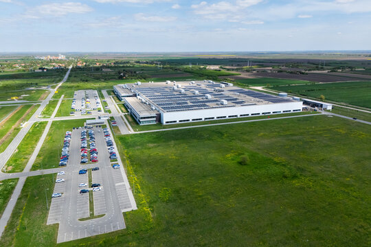 Aerial view of a modern logistics center with solar panels on the roof