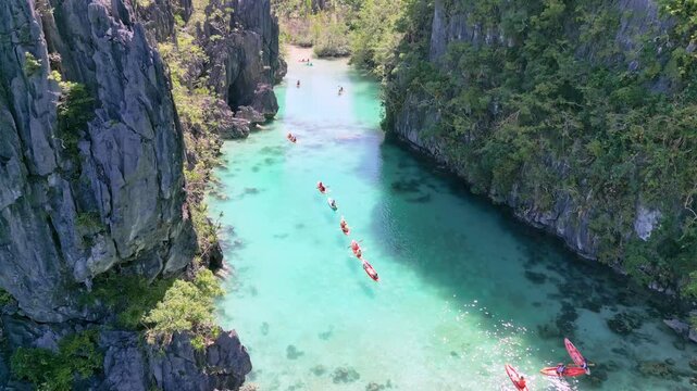 Drone view Journey Through Peaceful Limestone Canyon With Colorful Kayaks And Shimmering Blue Water
