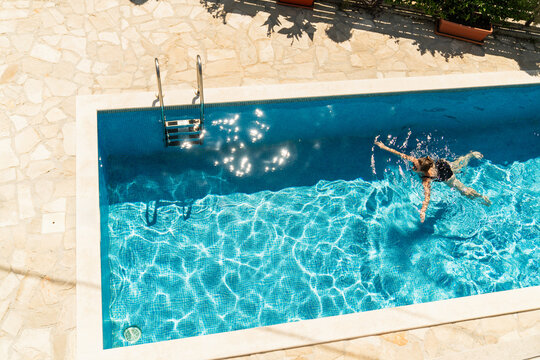 Adult 40 years old woman is resting in a swimming pool