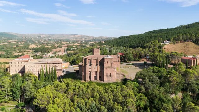 Majestic aerial view showing the medieval javier castle in navarre, spain. Historic monument and basilica surrounded by lush green forests and hills