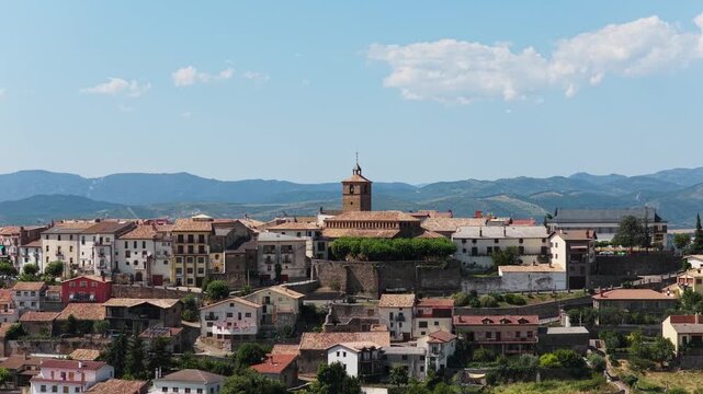 Picturesque aerial view of the historic town of Berdun in Huesca, Spain. Beautiful sunny day with Pyrenees mountains in the background
